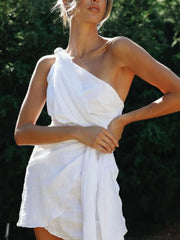 Front view showing the white dress's diagonal bodice and tied waist detail