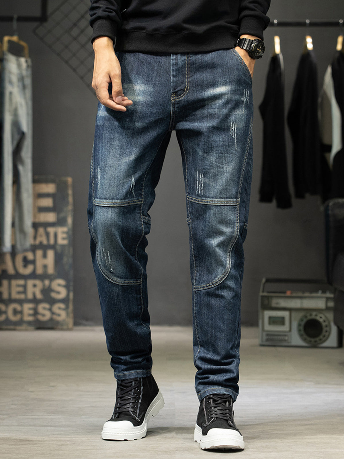 Front view of men's dark blue slim-fit jeans with faded thighs and stitched knee panels