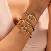 Model wearing gold-tone rhinestone chain bracelet with circular accent