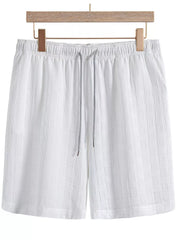 White textured shorts with elastic waist and drawstring, front view