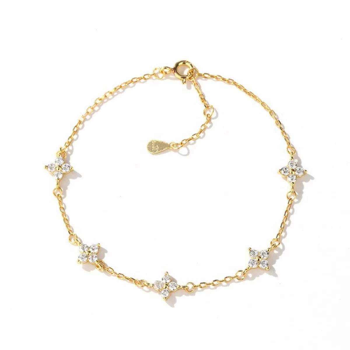 Gold-tone bracelet with small star-shaped charms arranged on a white background.