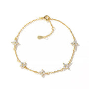 Gold-tone bracelet with small star-shaped charms arranged on a white background.