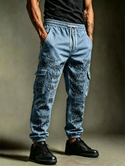 Model wearing light blue cargo joggers with black graffiti-style lettering and gathered ankle cuffs