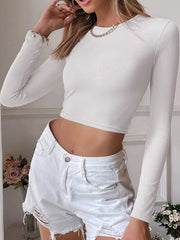White long-sleeve cropped top shown from the front at an angle