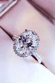 Side view of platinum-plated oval moissanite ring showing the raised setting