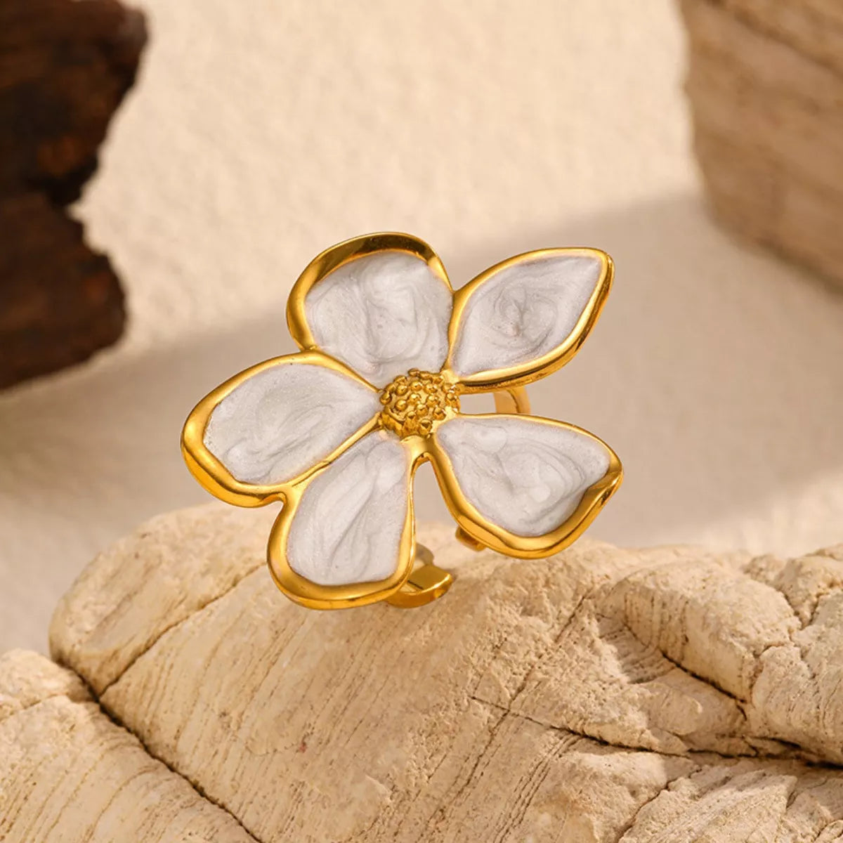 Close view of the white-petal gold-tone flower ring