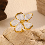 Close view of the white-petal gold-tone flower ring