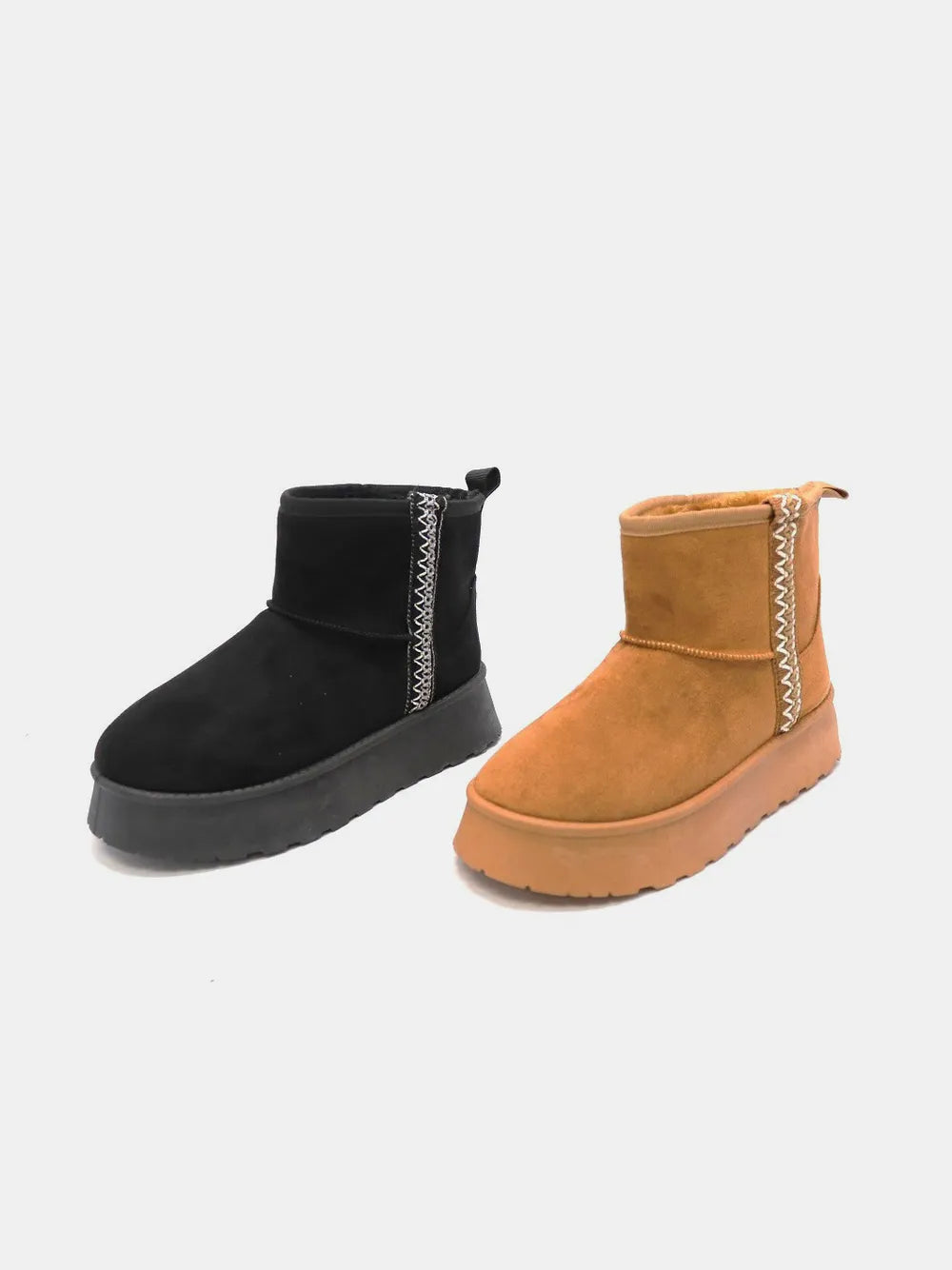 Black and tan round-toe platform ankle boots shown together
