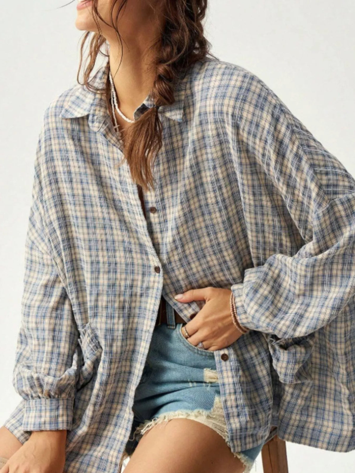 Blue and cream plaid oversized button-up shirt worn open over denim shorts