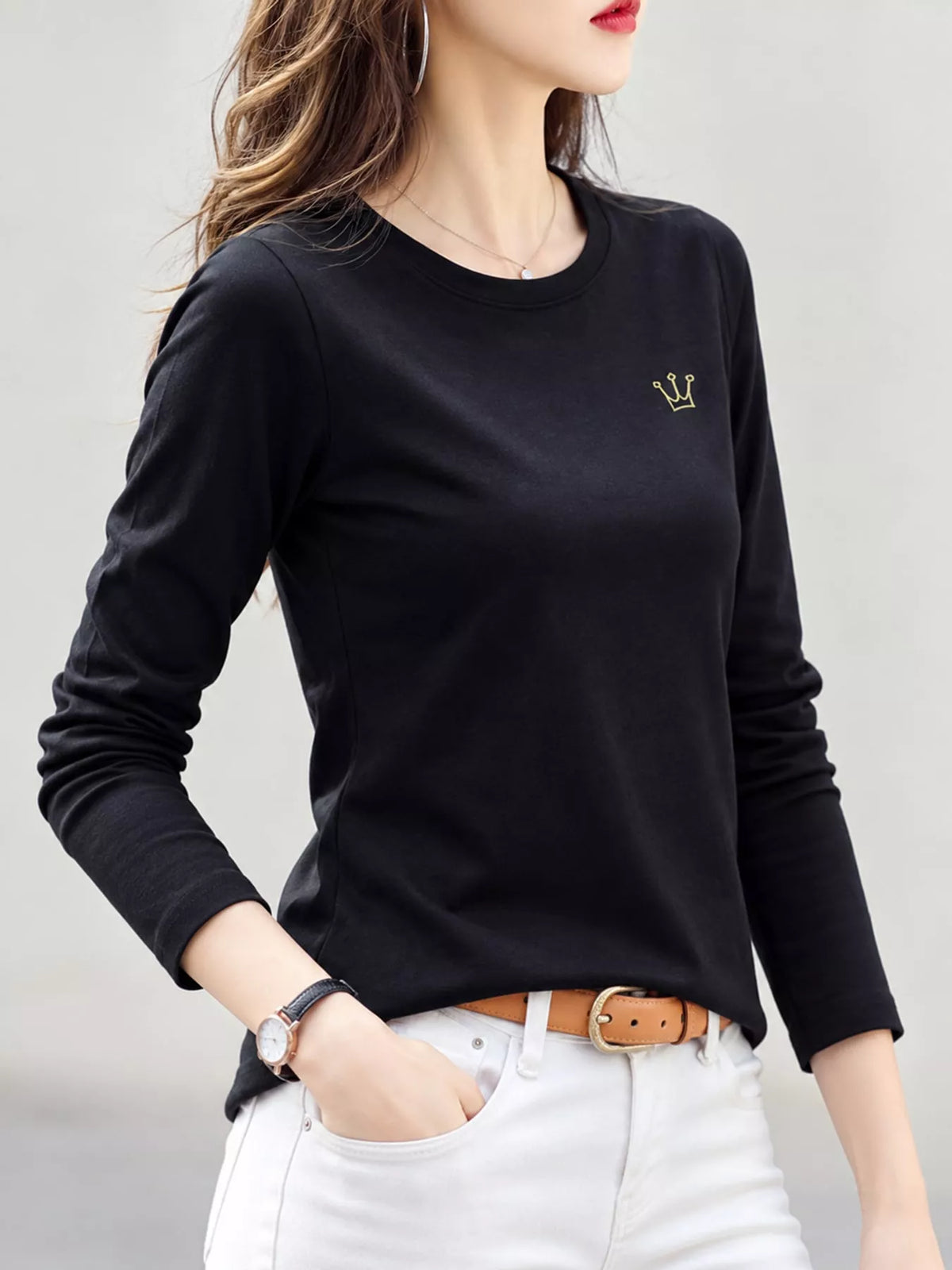 Model wearing black crown-embroidered long-sleeve T-shirt