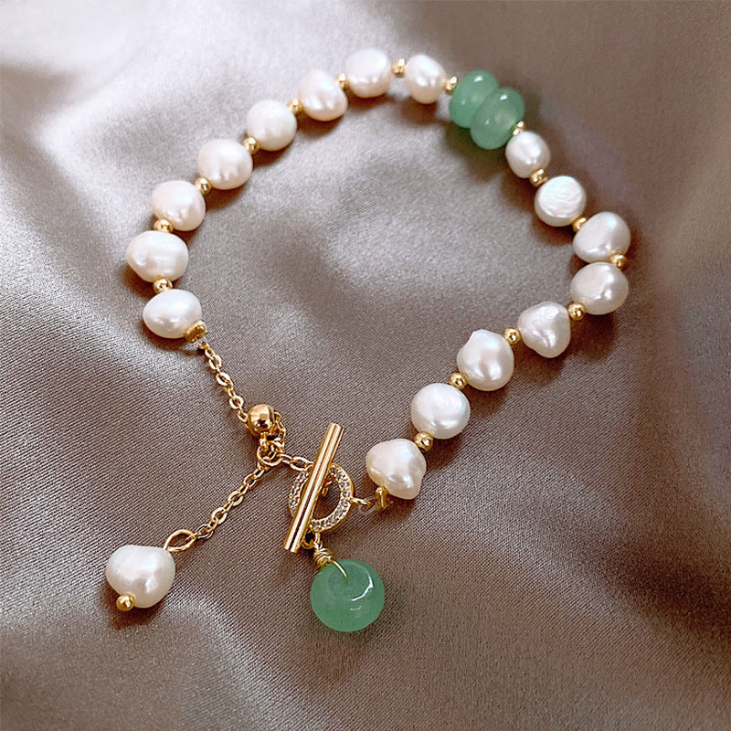 Close-up of pale green stones and freshwater pearl links