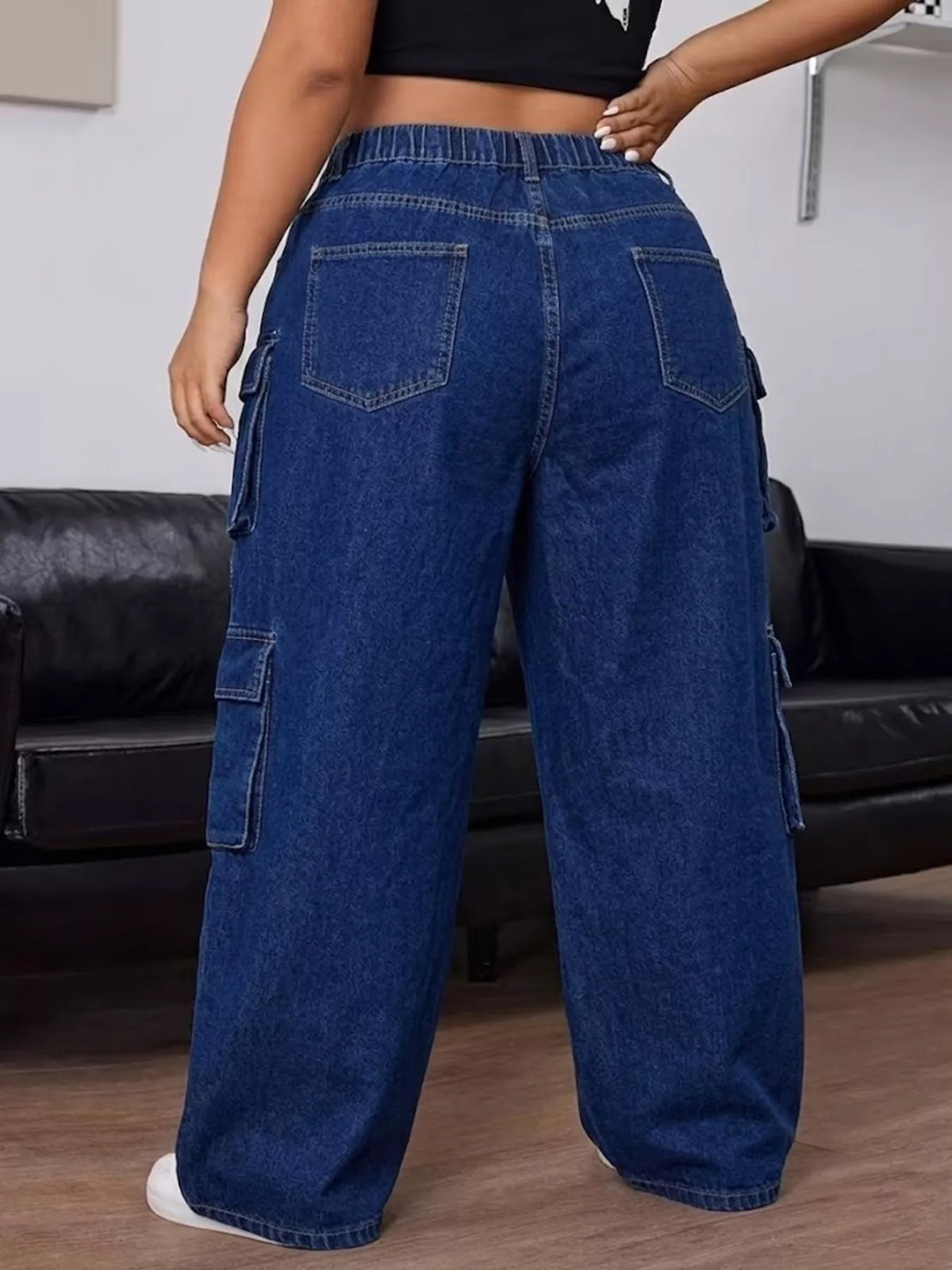Back view of dark blue cargo jeans showing the gathered waistband and rear patch pockets.