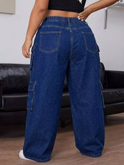 Back view of dark blue cargo jeans showing the gathered waistband and rear patch pockets.