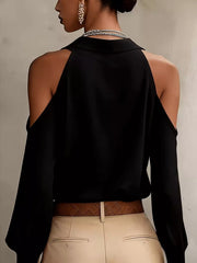 Back view of black blouse showing open shoulder detail.