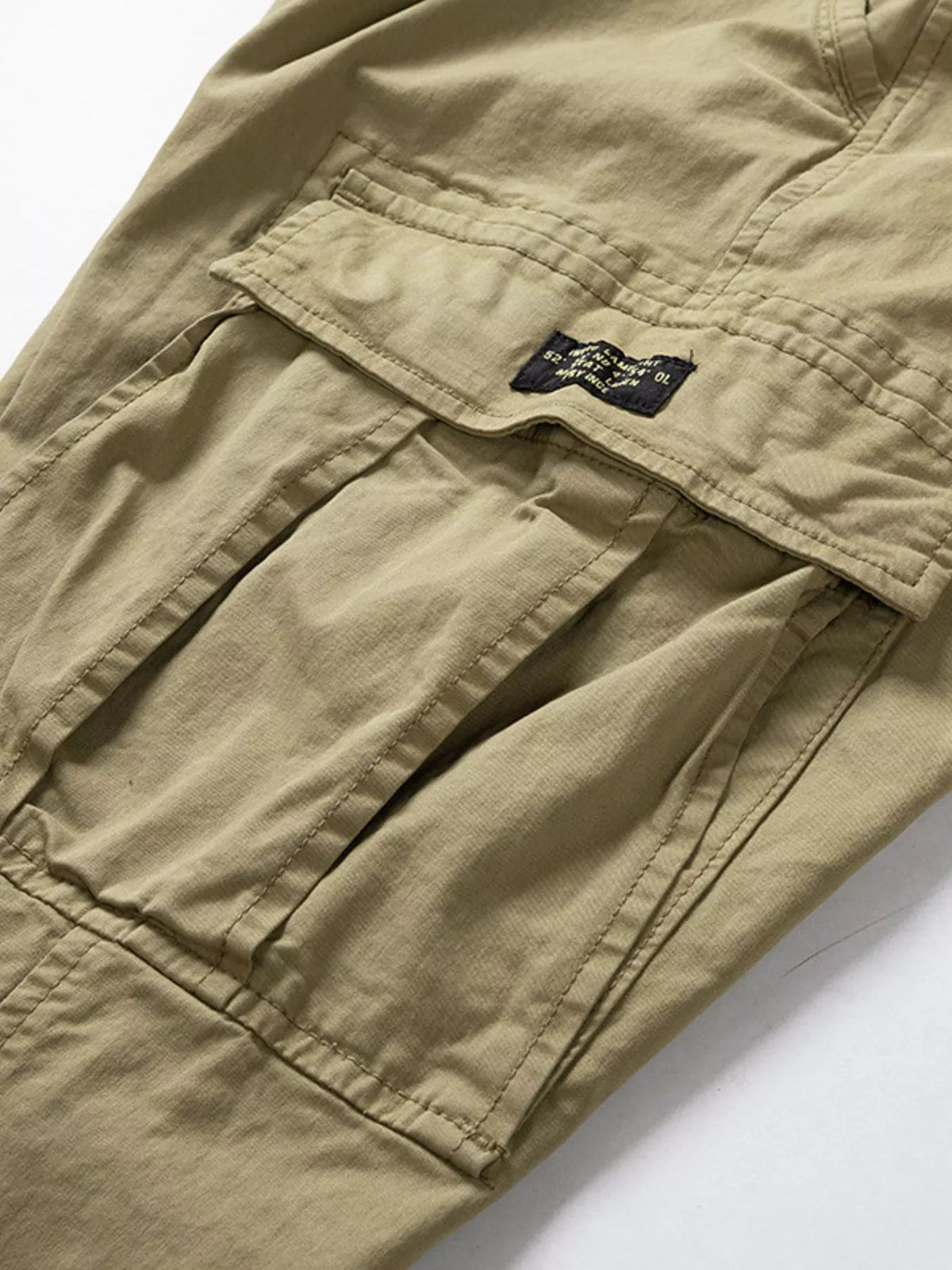 Close-up of khaki cargo pants side pocket and fabric label