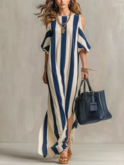Blue and white striped cold-shoulder maxi dress shown full length with handbag