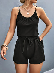 Front view of black romper with drawstring waist