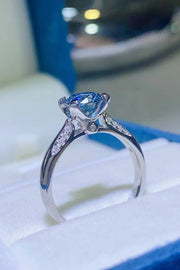Side view of sky-blue moissanite solitaire ring and band