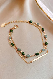 Reverse view of the layered bracelet's chain, oval stones and slim gold-tone bar