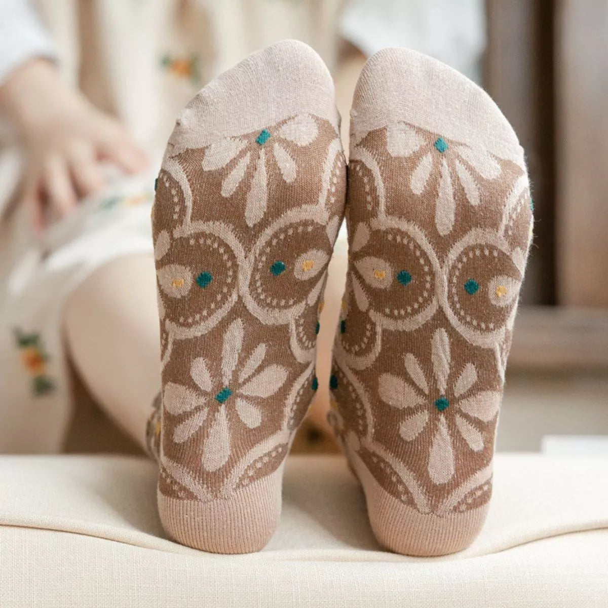 Close-up of brown textured socks with large cream flowers and turquoise accents