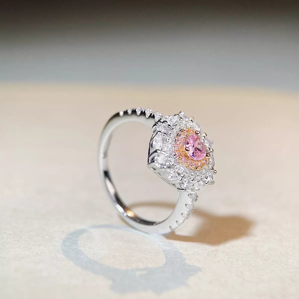 Close-up front view of the pink heart center and surrounding clear stones.