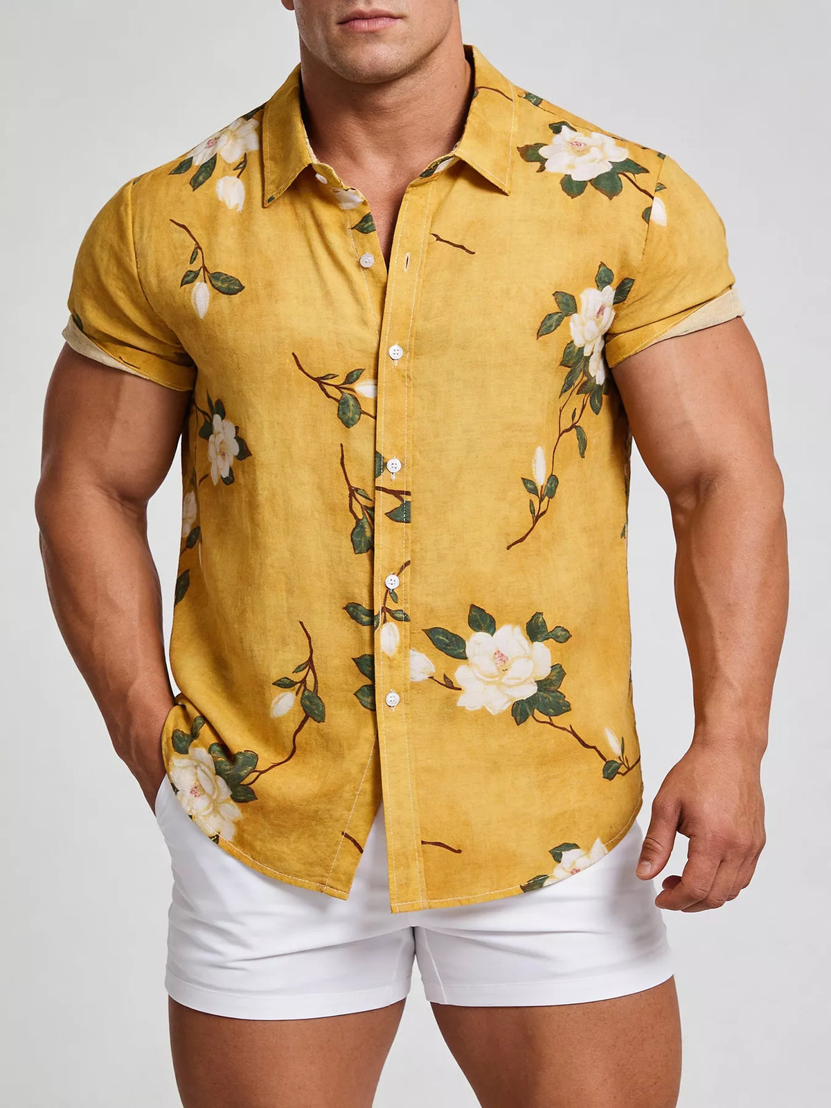 Model wearing a mustard-yellow floral short-sleeve shirt