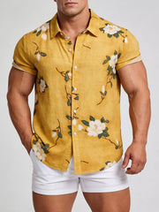 Model wearing a mustard-yellow floral short-sleeve shirt