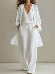 Full-length view of the ivory three-piece set with a V-neck cardigan, top and pants.