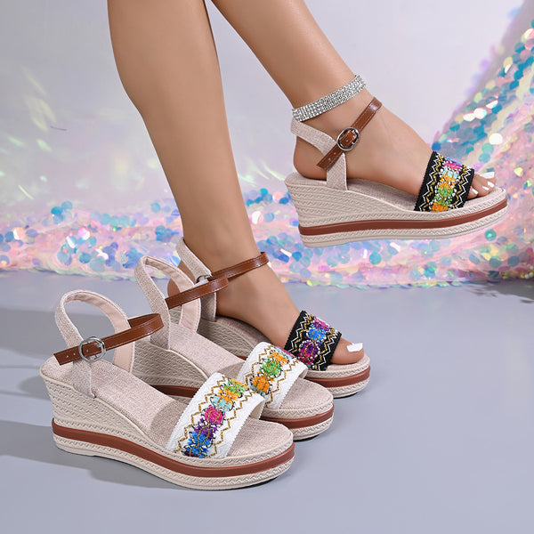 Beige open-toe wedge sandals with embroidered floral straps and brown ankle straps