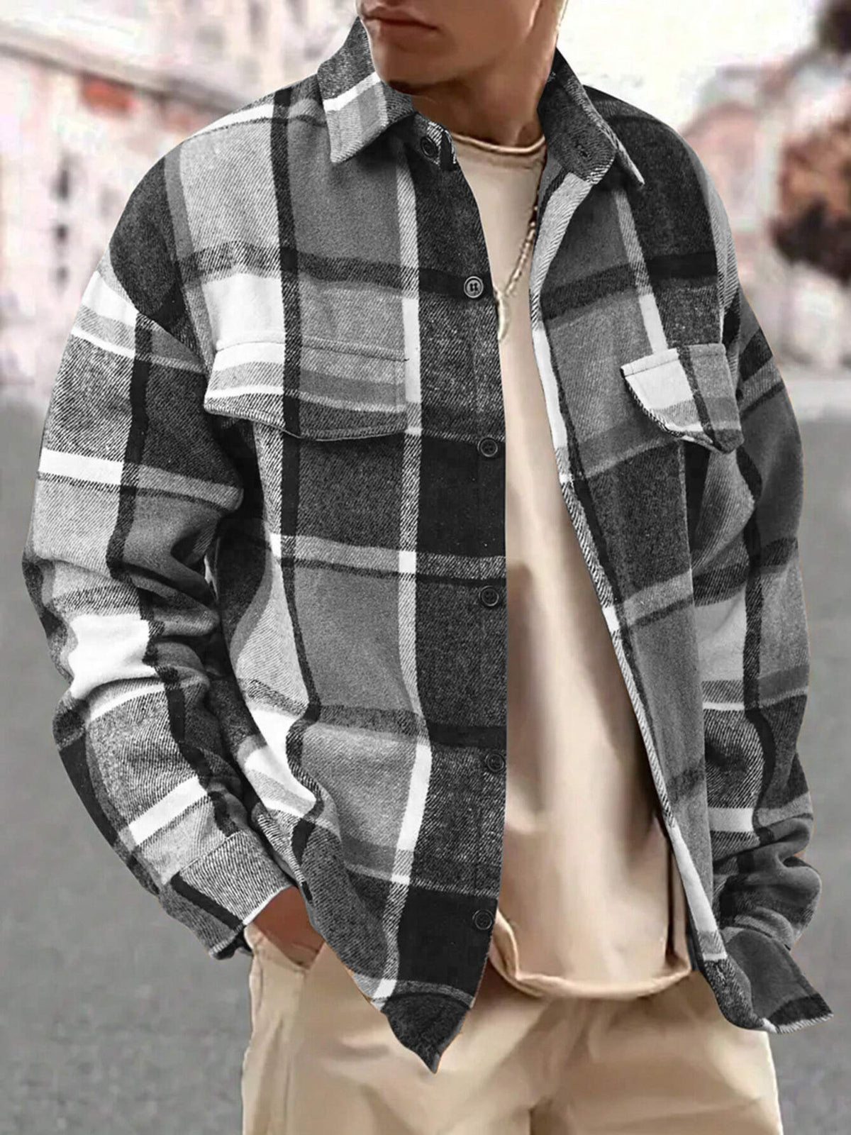 Model wearing a gray plaid shirt with contrasting tan grid lines