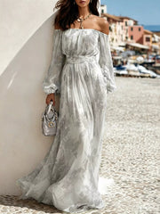 Grey-and-white patterned off-shoulder maxi dress with long balloon sleeves by the harbour