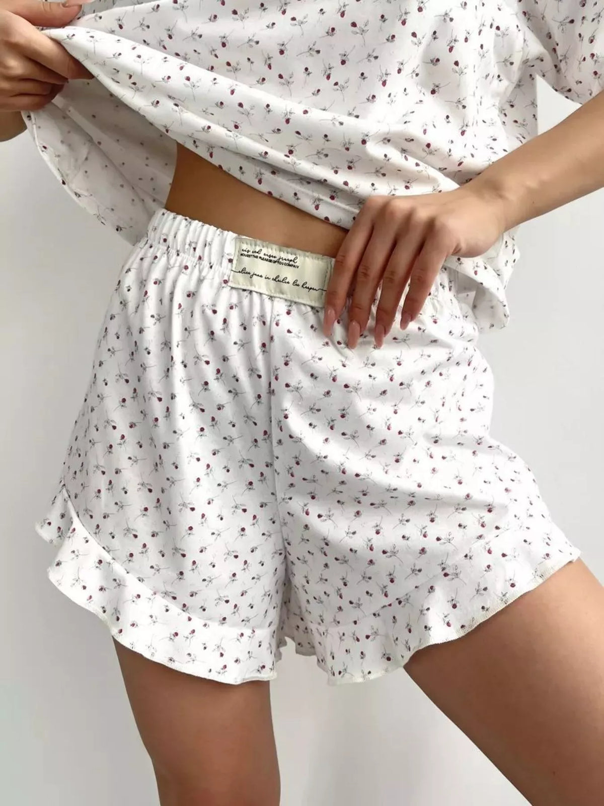 Close view of elastic-waist floral shorts and ruffled hem