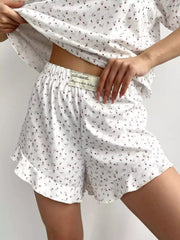 Close view of elastic-waist floral shorts and ruffled hem
