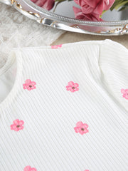 White ribbed top with pink flower print laid flat, neckline and button placket
