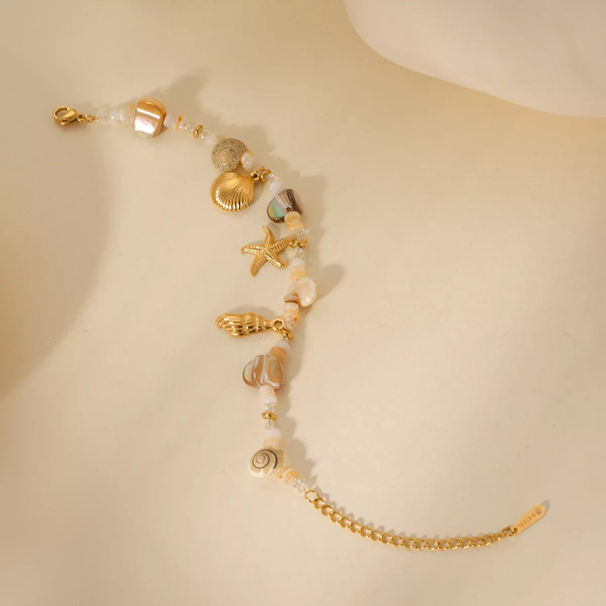 Detail of shell charm and gold-tone finish