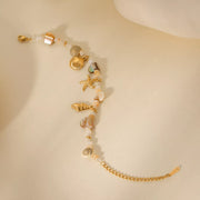 Detail of shell charm and gold-tone finish