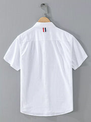 White short-sleeve button-up shirt with contrast stripe across the chest and collar