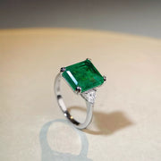 Side view of the silver band and raised green centre stone.