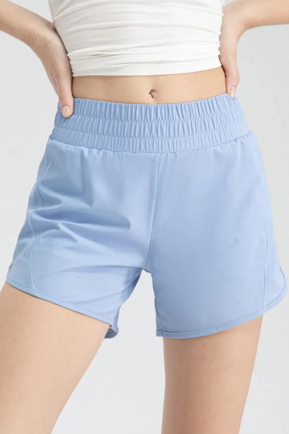 Front close-up of light blue active shorts with a wide elastic waistband