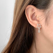 Close view of floral drop earring worn on ear