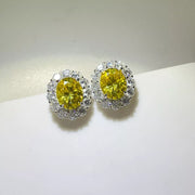Yellow oval moissanite studs shown together on a light surface.