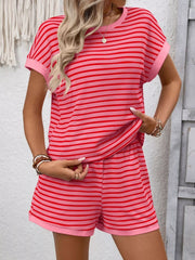 Closer view of the coral-pink striped set showing the relaxed top and shorts.