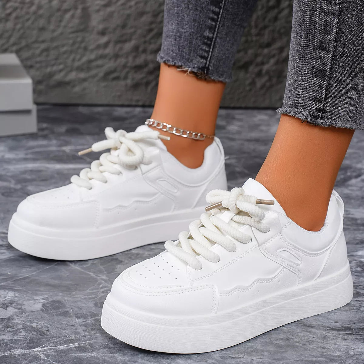 White platform sneakers worn with jeans