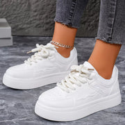 White platform sneakers worn with jeans