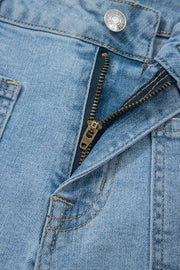 Close-up of front patch pocket and button on denim shorts