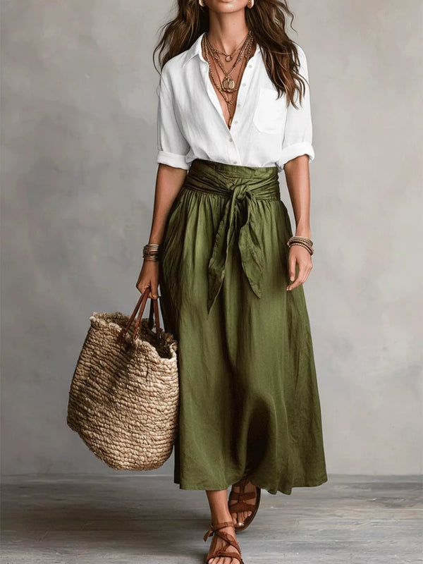 White button-down shirt tucked into an olive green midi skirt with a tied waist.