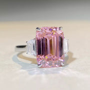 Close front view of the rectangular pink center stone and silver-tone setting