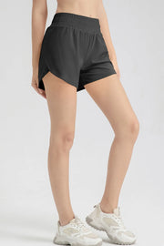 Side view of black active shorts with a curved split outer hem