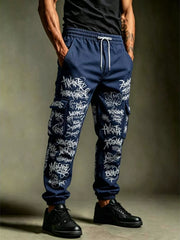 Model wearing navy cargo joggers covered in white graffiti-style lettering with a white waist drawstring