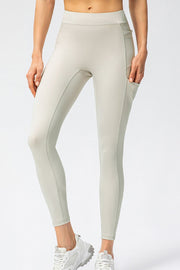 Close view of ivory high-waist leggings with side pocket and phone